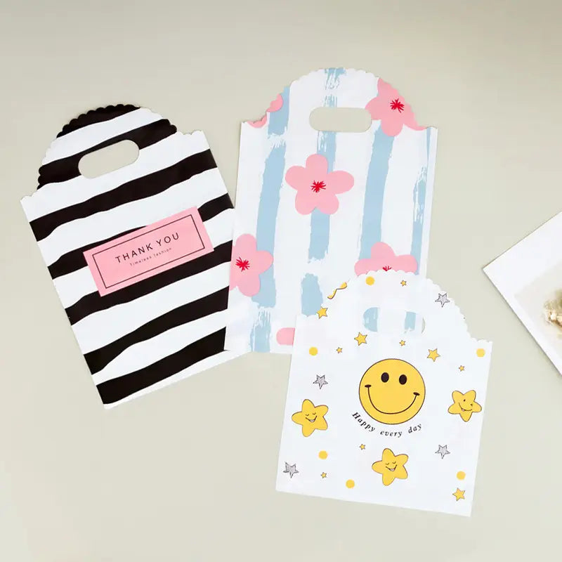 50pcs, 3 Styles Stripe Heart Smile wavy handle PVC gift bag - ByHome